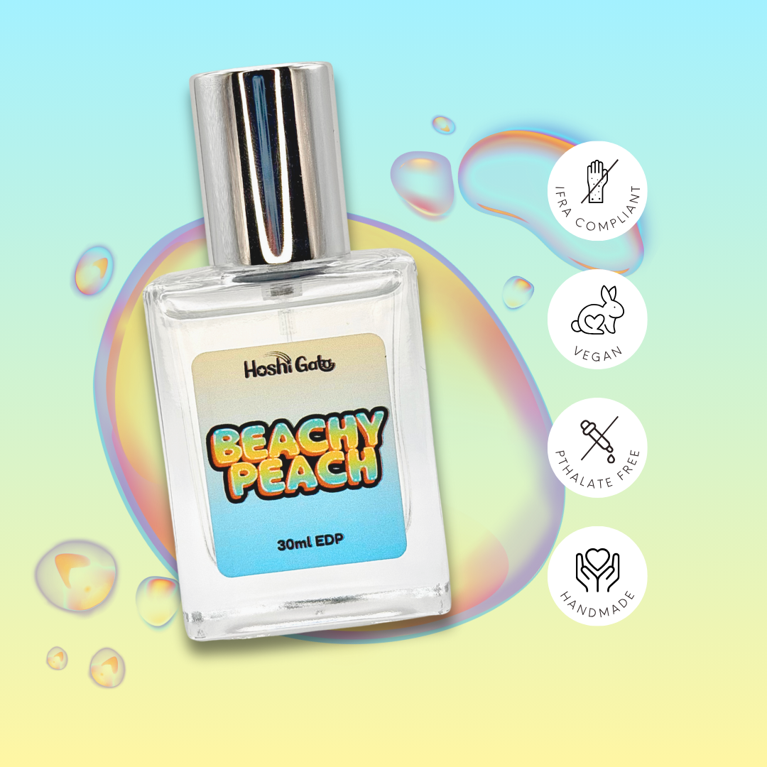 Perfume bottle labeled 'Beachy Peach' with brand logo on a colorful gradient background with "ifra compliant, vegan, pthalate free, and handmade tags