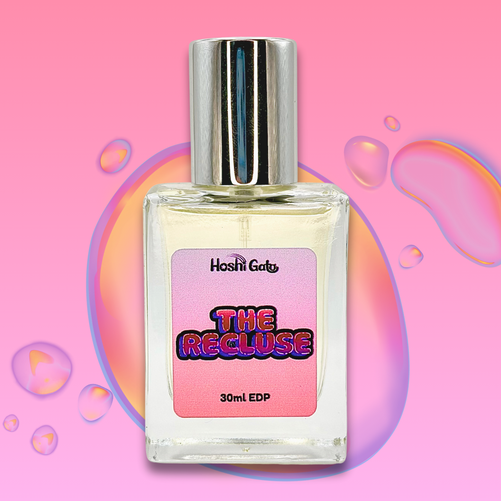 Perfume bottle labeled 'The Recluse' on a pink background with colorful bubbles.