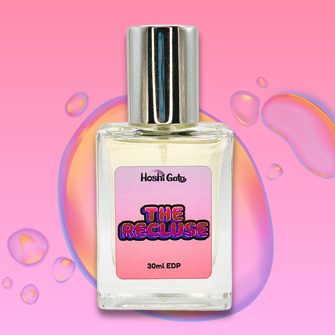 Perfume bottle labeled 'The Recluse' on a pink background with colorful bubbles.